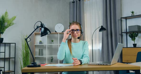 Girl in Headset which Posing on Camera while Taking off Glasses After Online Video meeting