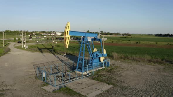 Crane boom shoting down oil pumpjack working near Ploiesti, Romania