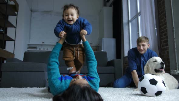 Little Baby Boy Flying with Help of Mom's Hands