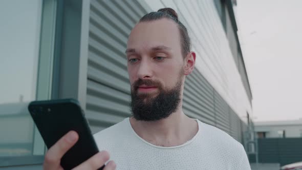 Male Millennial Hipster Holding Modern Smartphone Texting Message