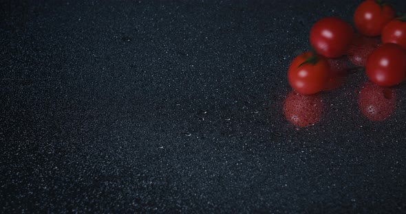 Tomatoes Closeup Falling in Water with Splash Droplets on Black Background Macro Shot Cooking Video