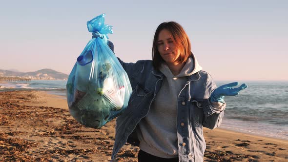 Woman holding trash bag full of plastic garbage, upset and shaking head. 