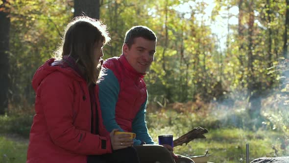 Traveling Young Couple Talking and Relaxing in Camping on Autumn Day