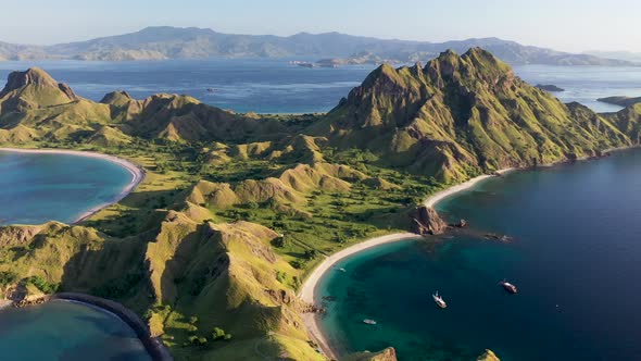 Panorama of Padar island Indonesia with tour boats below and Komodo in the background, Aerial pan ri
