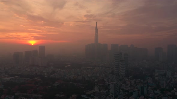 early morning urban aerial tracking shot with fog featuring sunrise, architecture river and dramatic