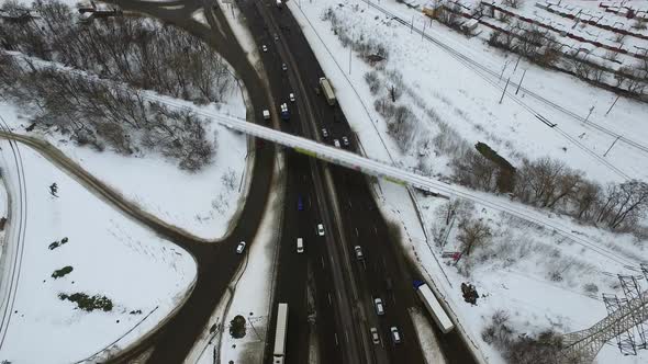 Car Moving on Freeway Overpass at Winter. Drone View Road Intersection Highway