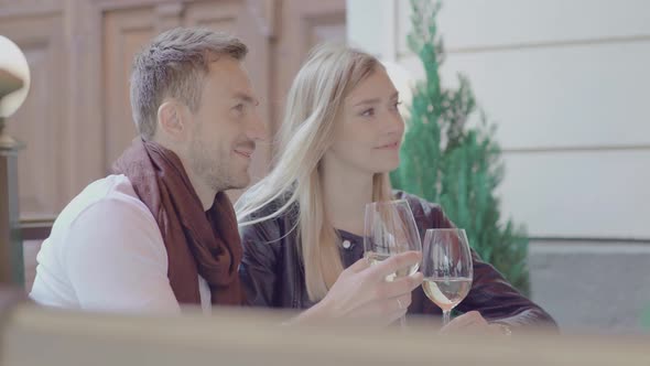 Couple On Date Drinking Wine In Cafe Outdoors