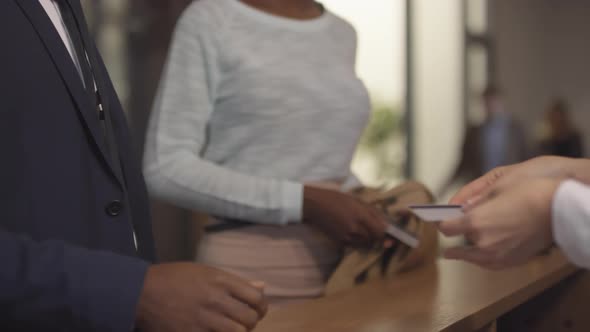 Reception Manager Handing Key Cards to Guests