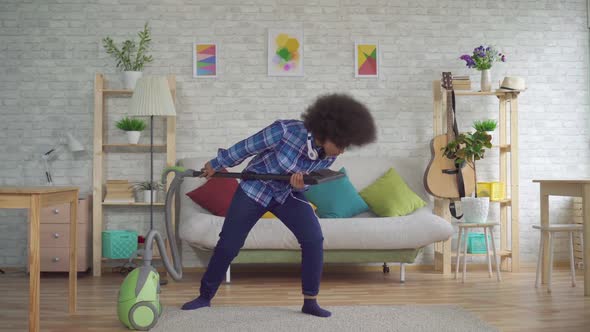 Expressive Positive African American Young Woman Housewife Busy with Homework Vacuuming and Singing