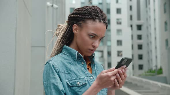 Shocked Frustrated African Mixed Race Woman Student Feel Stressed Look at Smartphone Screen Worried