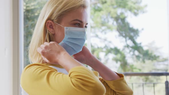 Woman wearing face mask at home