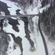 High Aerial View of a bridge over river Gauja in  Sigulda, Latvia in a snowstorm - VideoHive Item for Sale