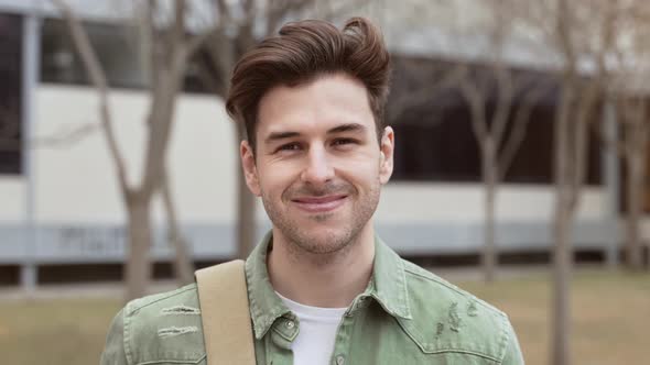 Positive Handsome Young Male Student Smiling in University Campus