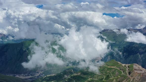 Caucasus Mountains and Town Under Clouds