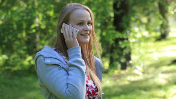 Woman chatting on her mobile phone outdoors