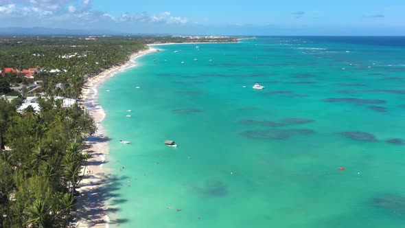 Tropical Coastline with Resorts Palm Trees and Caribbean Sea with Floating Boats and People Having