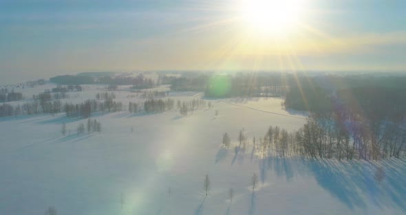 Aerial View of Cold Winter Landscape Arctic Field Trees Covered with Frost Snow Ice River and Sun