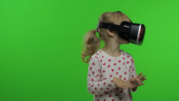 Child Girl Using VR Helmet To Play Simulation Game App. Watch Virtual Reality 3d Video. Chroma Key