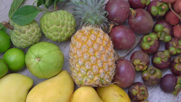 Lots of Tropical Fruits on a Wooden Background