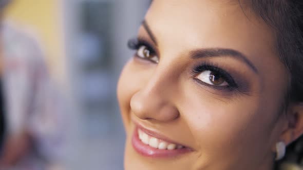 Closeup of Attractive Young Woman with Beautiful Makeup Smiling at Camera