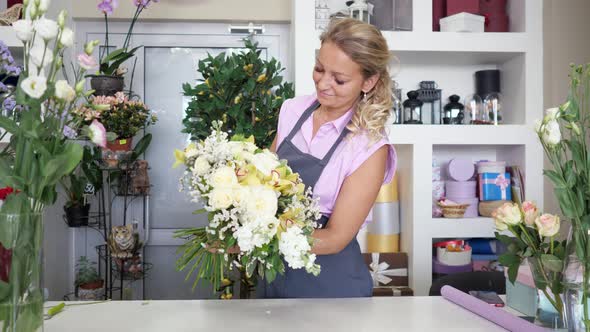 Woman Professional Florist Makes Huge Flower Bouquet in Floristic Studio