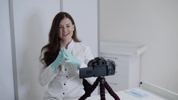 Doctor in Uniform Recording Video for Medical Vlog at Camera in Modern Clinic