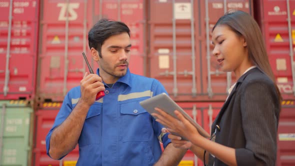 Two engineer male and female worker dockers in checking examine discussion