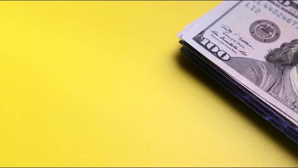 Stack of US Dollar Bills on Table