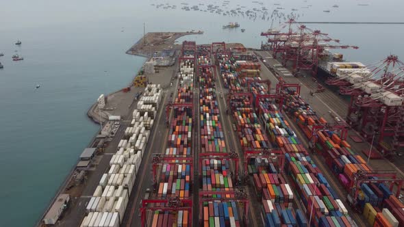 Drone video of shipping container yard in sea port of Callao in Peru. Many colored containers can be