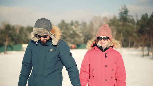 Couple Walking And Enjoying Winter. Freezing Day On Holiday Vacation Trip. Fun In Cold Day.