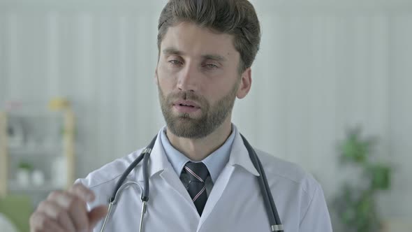 Serious Young Doctor Saying No with Finger Sign