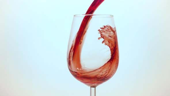 Red wine pouring in a glass