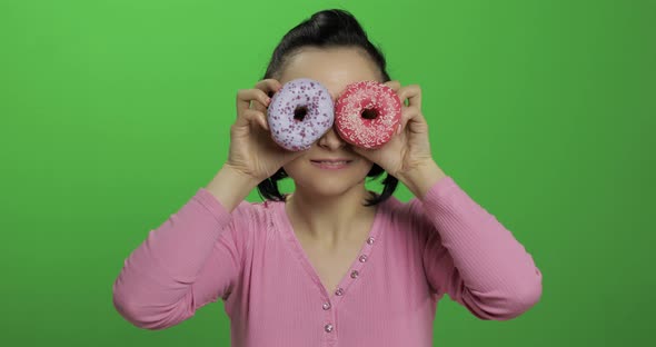 Happy Beautiful Young Girl Posing and Having Fun with Donuts. Chroma Key