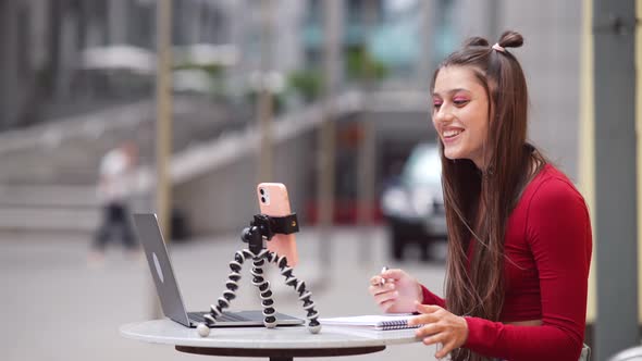 Freelance Woman in a Summer Cafe Communicating Via Video Link