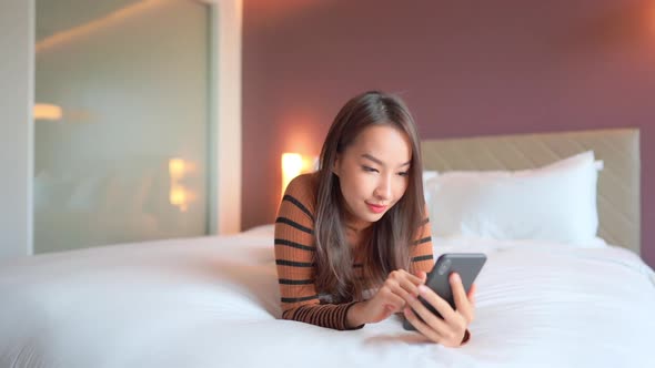 Young asian woman use smart phone in room
