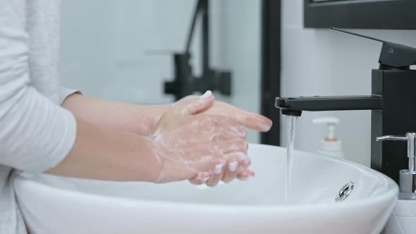 Caucasian Woman Wash Hands with Soft Soap