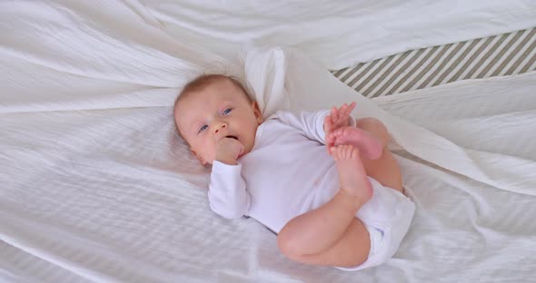 Cute Newborn Baby Sucks a Finger in His Mouth
