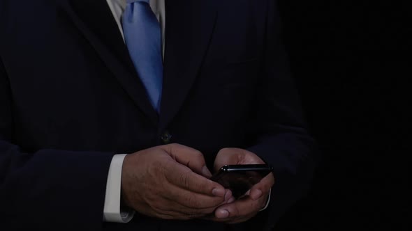 Business Man Texts On Smart Phone