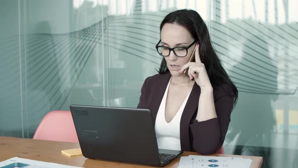 Busy Female CEO Wearing Suit and Glasses