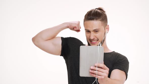 Portrait of Young Handsome Man Speaking on Tablet