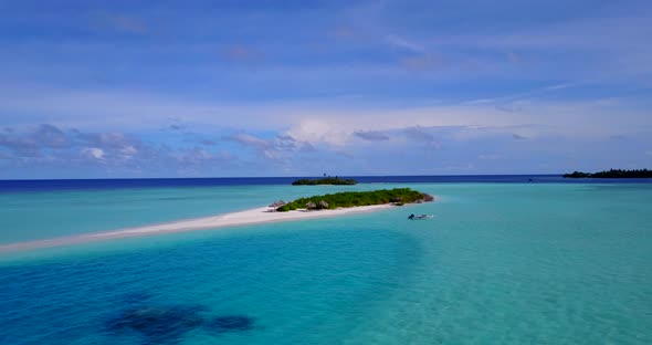 Beautiful drone tourism shot of a sunshine white sandy paradise beach and blue sea background in col