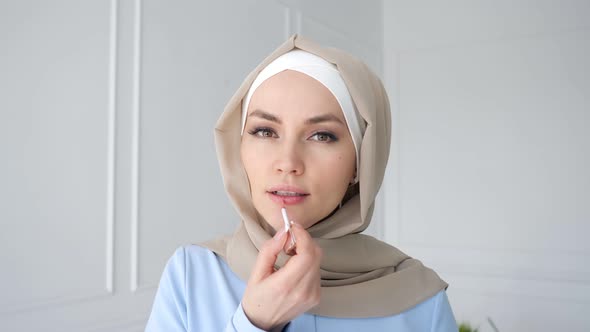 Muslim Woman Is Applying Compact Powder Looking at Mirror