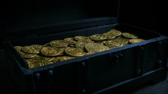 Chest Opens In Dark Room Showing Bright Gold Coins