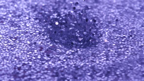 Dropping glitter into water filled with glitter, Slow Motion