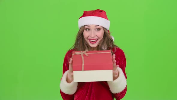 Girl in a Snow Maiden Costume Holds a Gift in Her Hand. Green Screen. Close Up