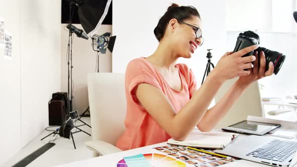 Graphic designer looking at photos on digital camera