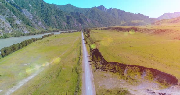 Aerial Rural Mountain Road and Meadow at Sunny Summer Morning