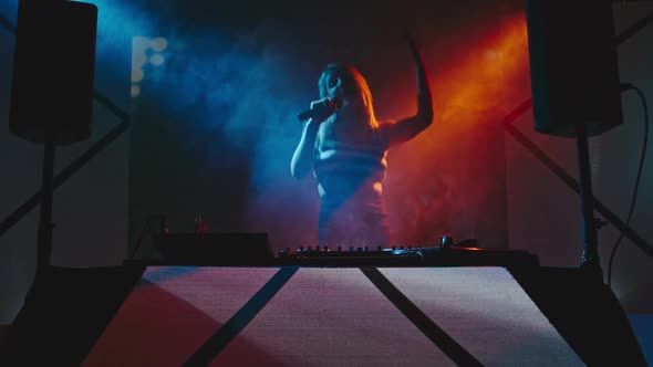 Dancing Woman Playing Decks in Club