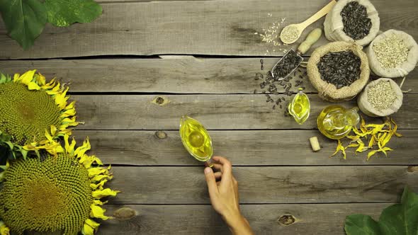 Sunflower Oil and Seeds on an Old Wooden Table. Flat Lay.