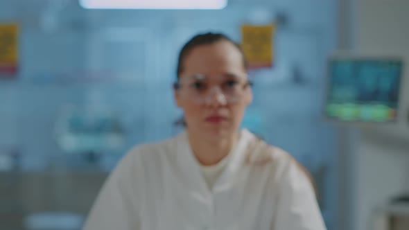 Portrait of Microbiologist Wearing Protective Goggles in Laboratory
